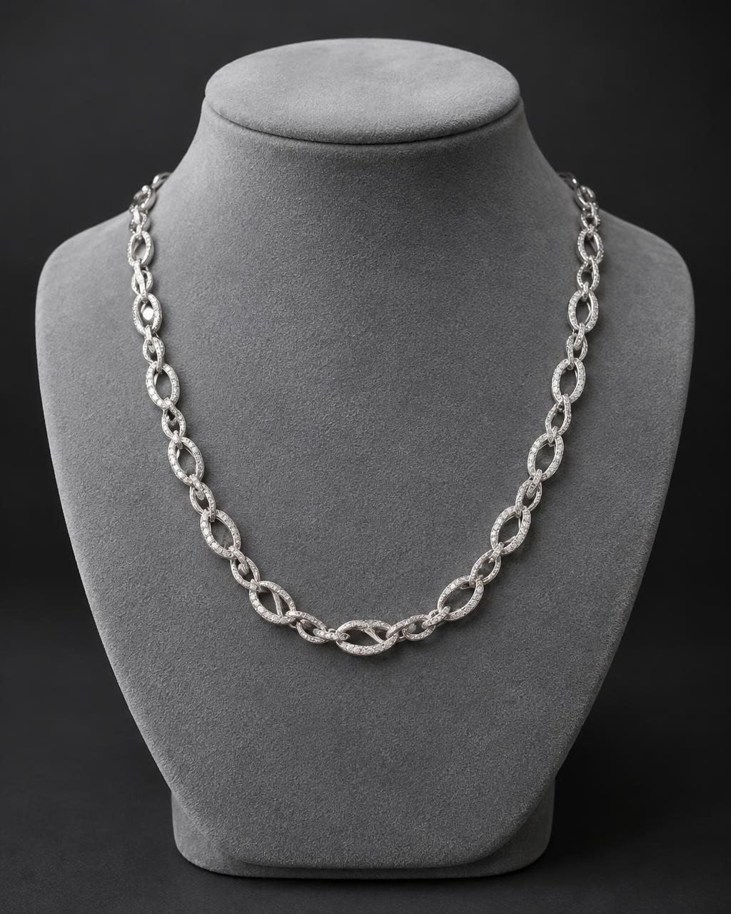Diamond infinity link chain on a gray necklace bust